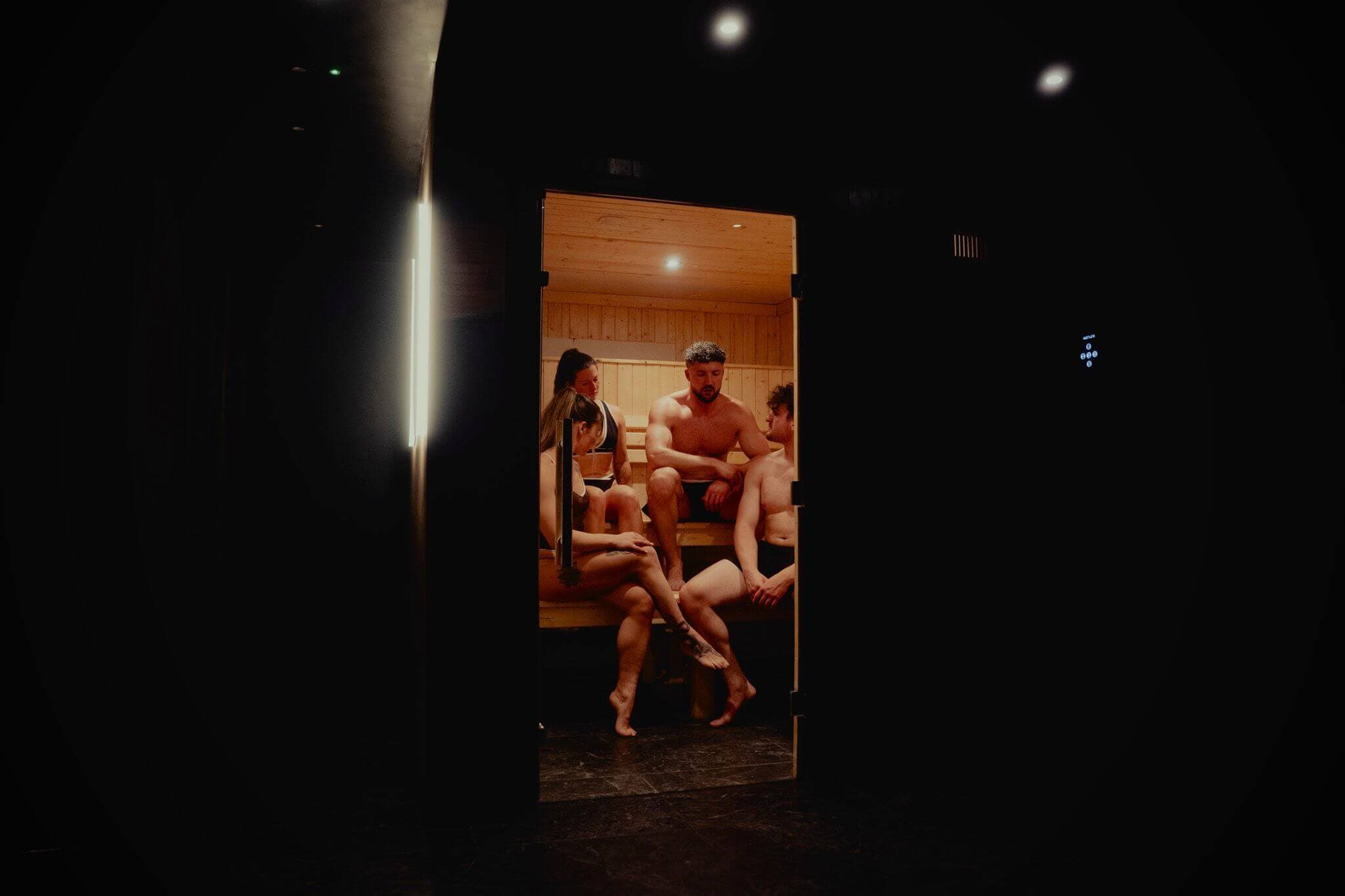 A group of friends enjoying an exclusive private sauna session at Peak Recover